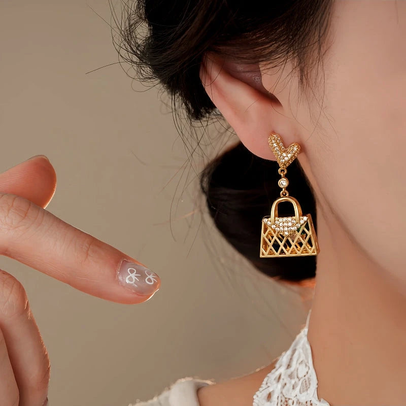 Angled view of the 14K Gold-Plated Elegant Zircon Heart Bag Tassel Earrings