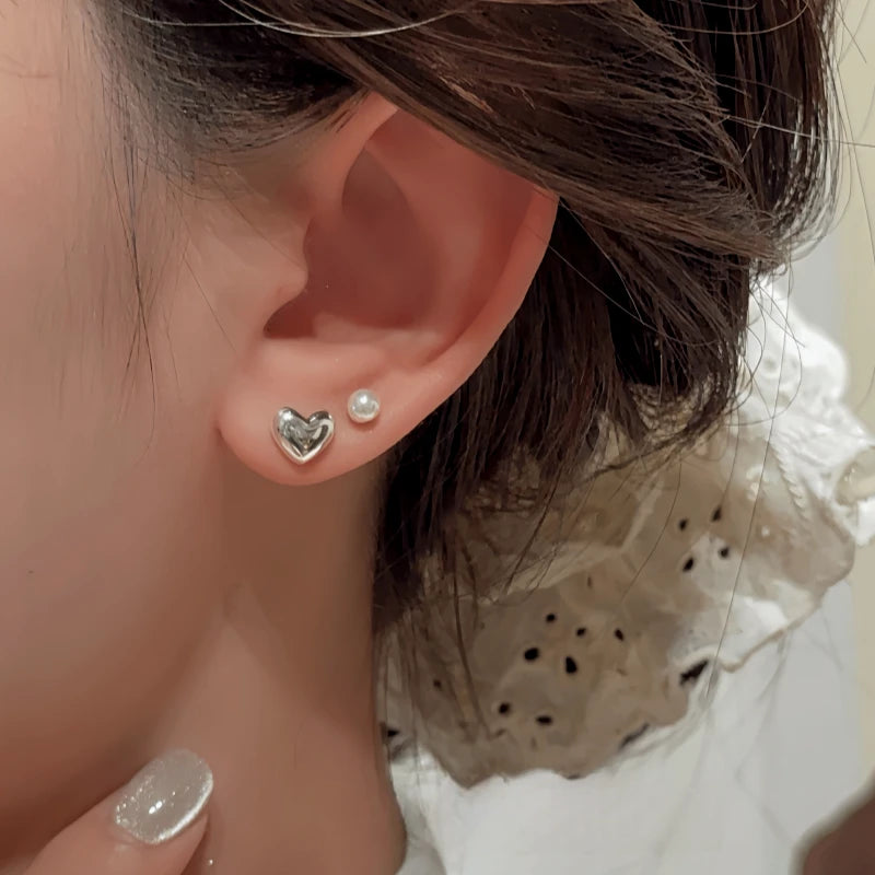 Close-up detail of the sparkling zircons and plating on the silver heart earrings