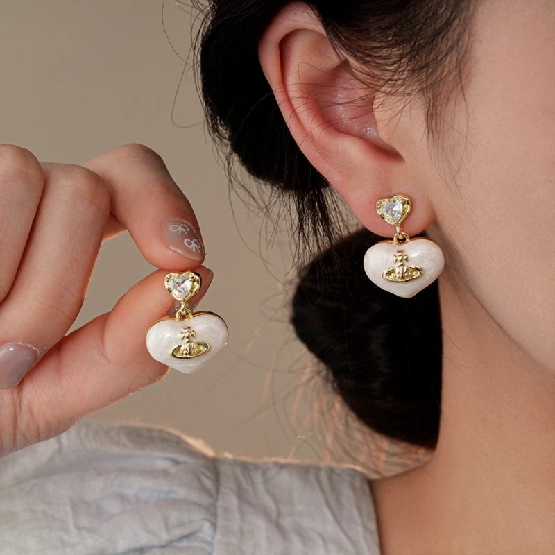 Model showcasing the dangle and style of the 14K Gold-Plated Elegant Zircon Heart Earrings