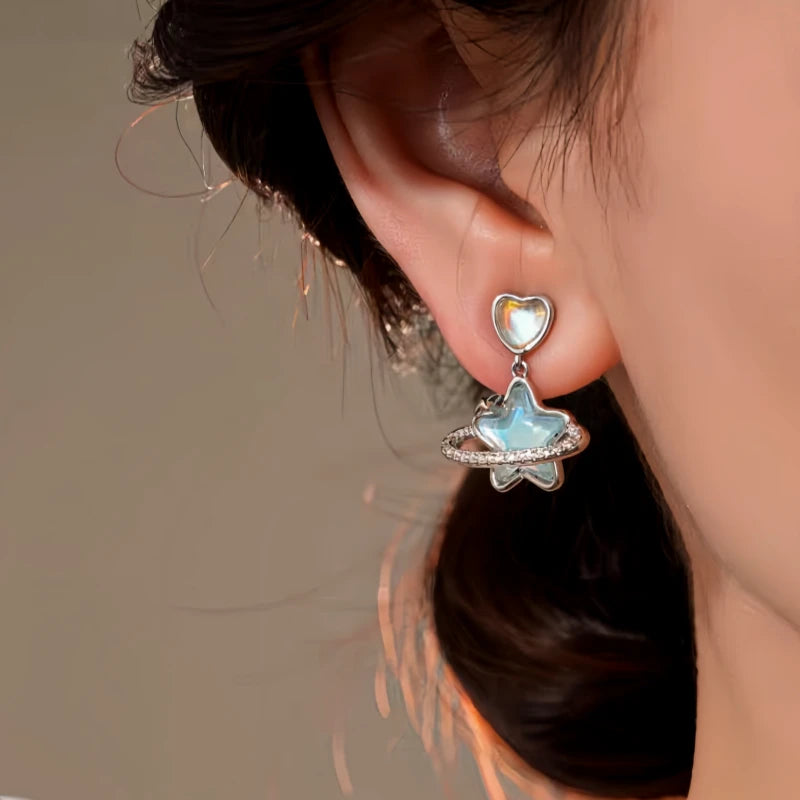 Close-up detail of the sparkling zircons and plating on the gold heart earrings