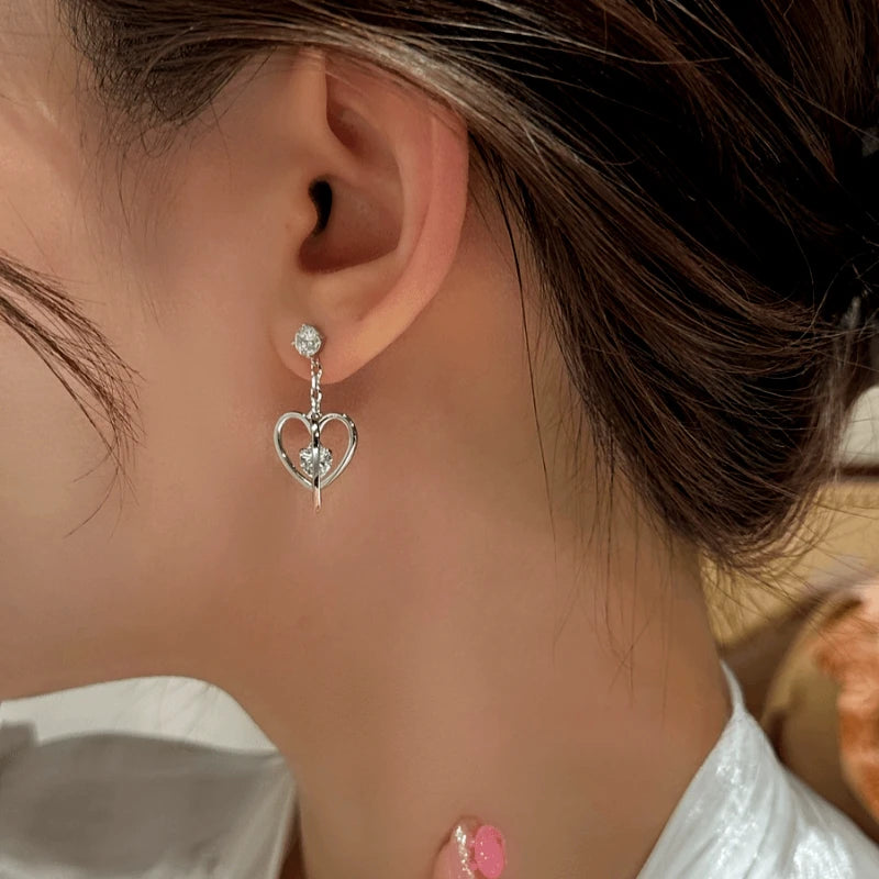 Model showcasing the dangle and style of the 14K Gold-Plated Elegant Zircon Heart Earrings