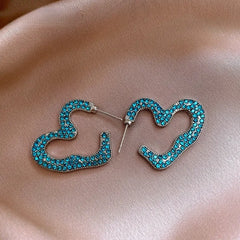 Model showcasing the dangle and style of the 14K Gold-Plated Elegant Zircon Heart Earrings