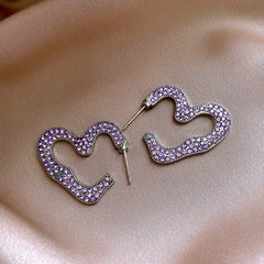 Close-up detail of the sparkling zircons and plating on the blue heart earrings