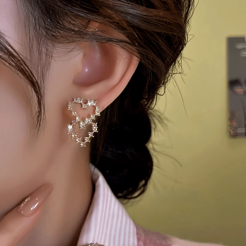 Model showcasing the dangle and style of the 14K Gold-Plated Elegant Zircon Heart Earrings