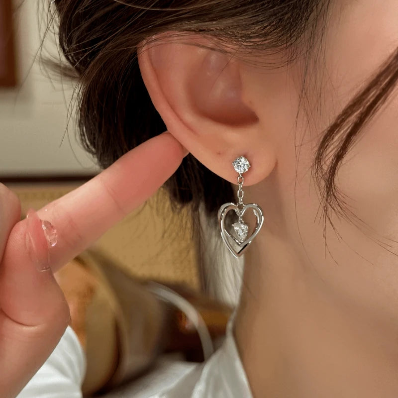 Close-up detail of the sparkling zircons and plating on the silver heart earrings