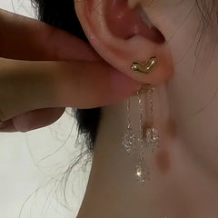 Model showcasing the dangle and style of the 14K Gold-Plated Elegant Zircon Heart Leaf Tassel Earrings