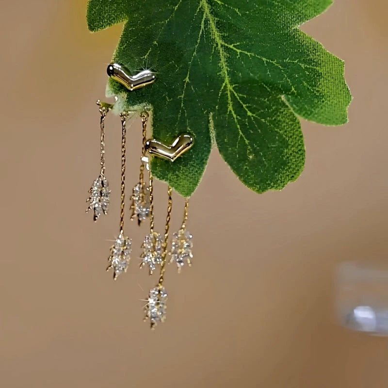 Close-up detail of the sparkling zircons and plating on the gold tassel earrings