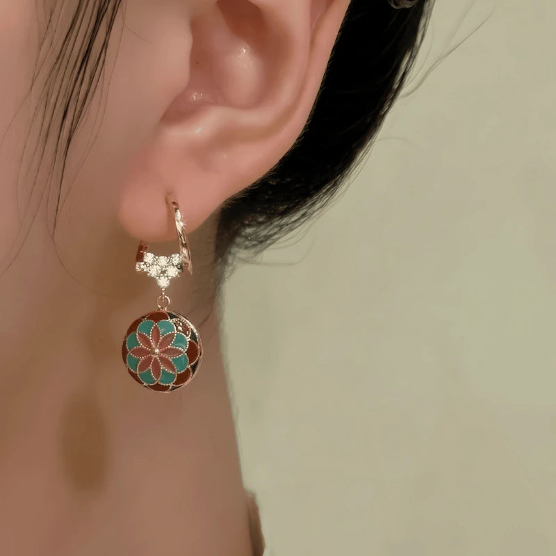 Model showcasing the dangle and style of the 14K Gold-Plated Elegant Zircon Heart Oil Drop Earrings