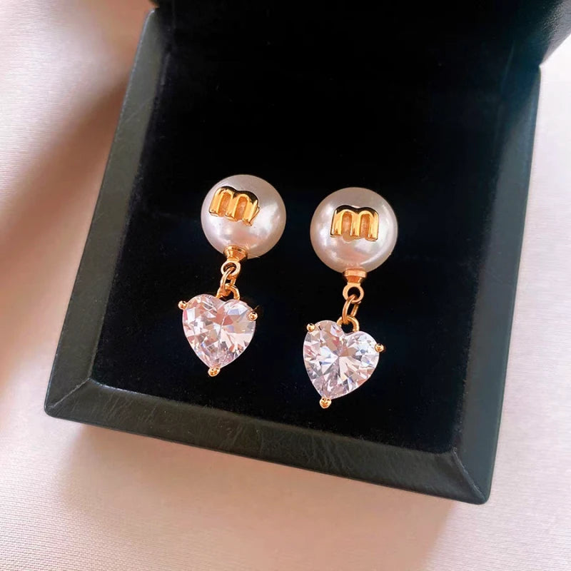 Close-up detail of the sparkling zircons and plating on the gold pearl earrings