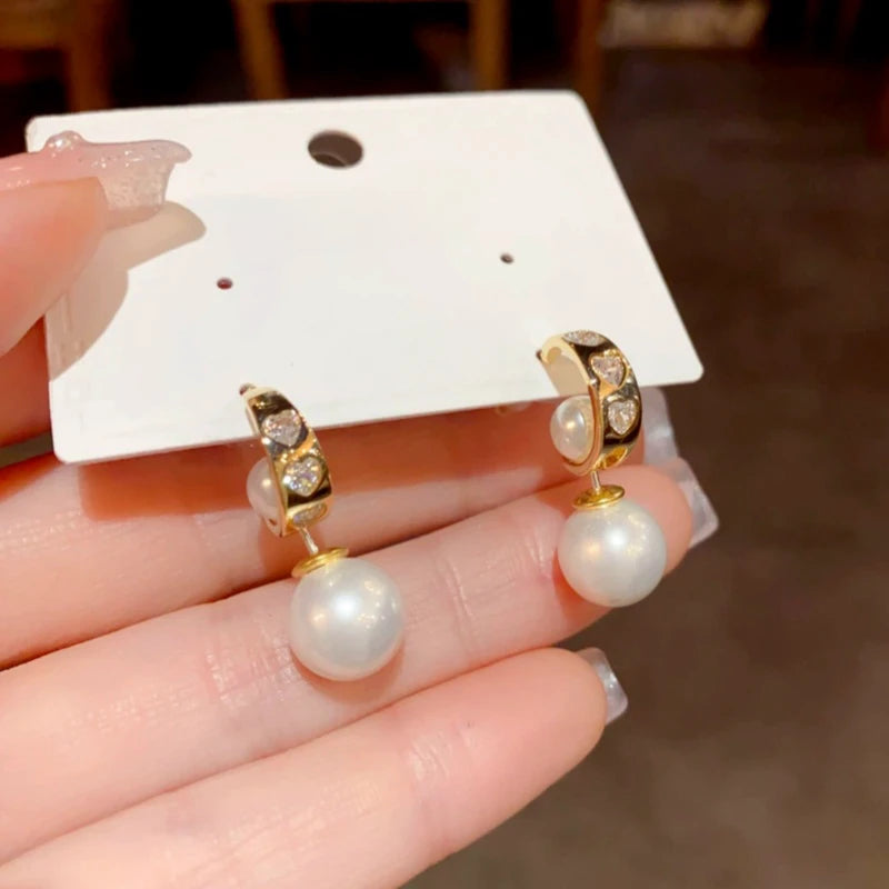 Angled view of the 14K Gold-Plated Elegant Zircon Heart Pearl Earrings