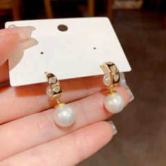 Angled view of the 14K Gold-Plated Elegant Zircon Heart Pearl Earrings