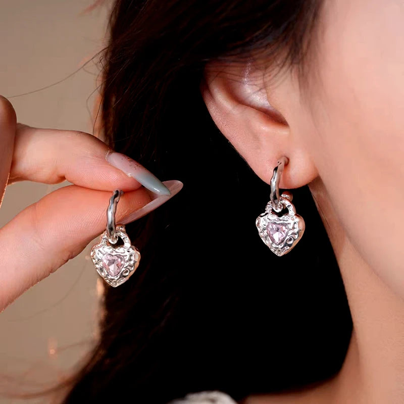 Model showcasing the dangle and style of the 14K Gold-Plated Elegant Zircon Heart Pendant Earrings