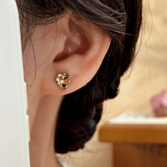 Close-up detail of the sparkling zircons and plating on the brown stud earrings