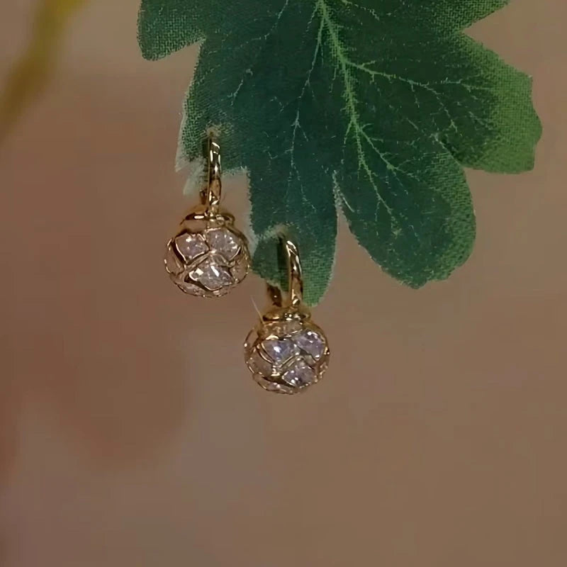 Angled view of the 14K Gold-Plated Elegant Zircon Hollow Ball Earrings