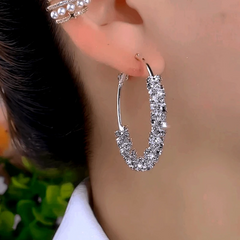 Model showcasing the dangle and style of the 14K Gold-Plated Elegant Zircon Hoop Earrings