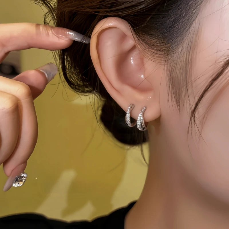 Model showcasing the dangle and style of the 14K Gold-Plated Elegant Zircon Hoop Earrings