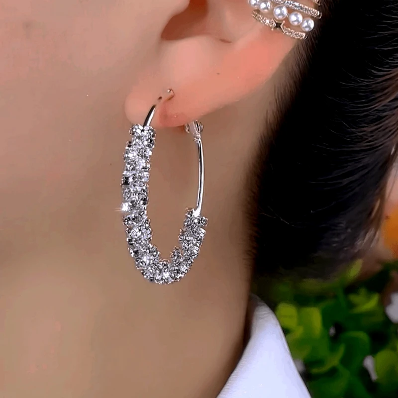 Close-up detail of the sparkling zircons and plating on the gold hoop earrings