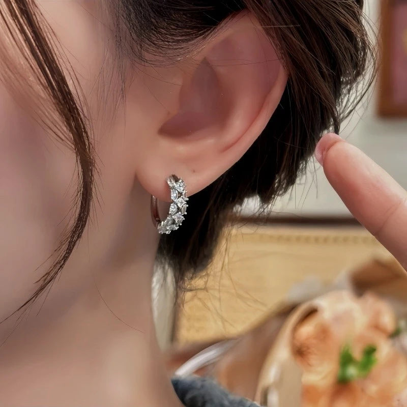 Model showcasing the dangle and style of the 14K Gold-Plated Elegant Zircon Hoop Earrings