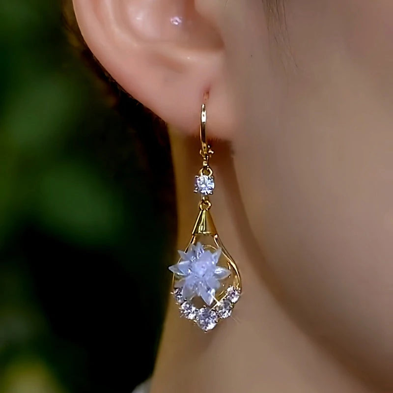 Close-up detail of the sparkling zircons and plating on the gold flower earrings