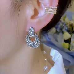 Close-up detail of the sparkling zircons and plating on the silver geometric earrings