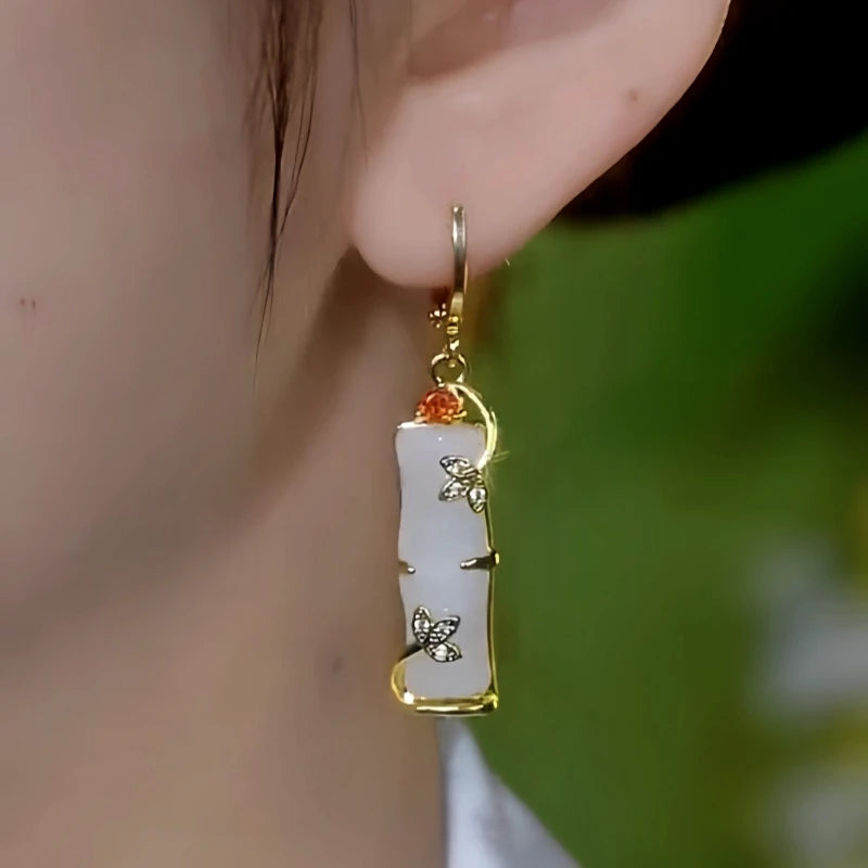 Close-up detail of the sparkling zircons and plating on the gold bamboo earrings