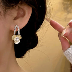 Model showcasing the dangle and style of the 14K Gold-Plated Elegant Zircon Jasmine Flower Earrings