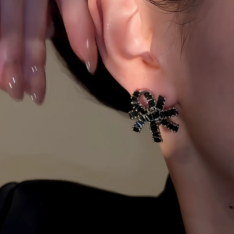 Model showcasing the dangle and style of the 14K Gold-Plated Elegant Zircon Knotted Flower Earrings