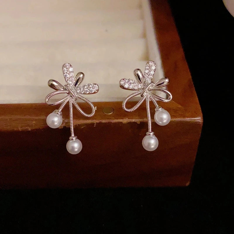 Angled view of the 14K Gold-Plated Elegant Zircon Knotted Pearl Earrings