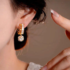Model showcasing the dangle and style of the 14K Gold-Plated Elegant Zircon Lace Ball Earrings