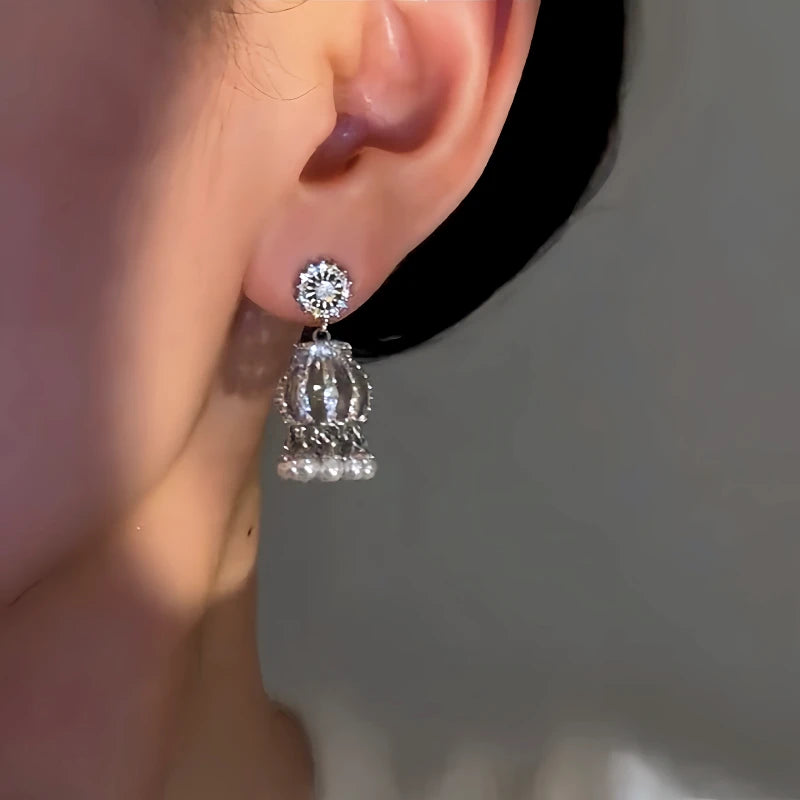 Close-up detail of the sparkling zircons and plating on the silver tassel earrings