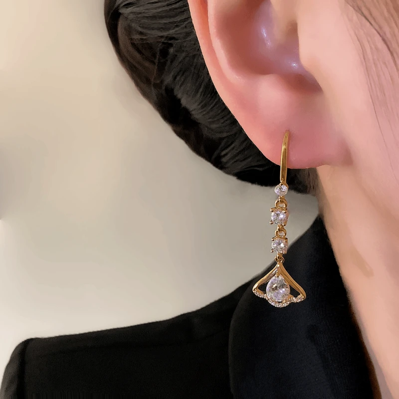 Close-up detail of the sparkling zircons and plating on the gold threader earrings