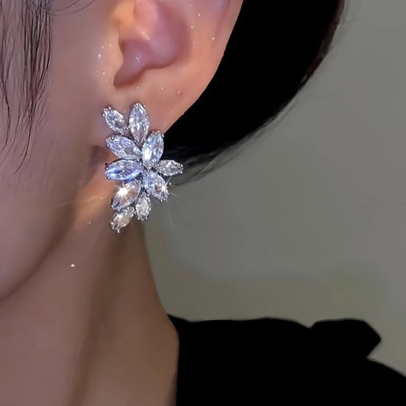 Model showcasing the dangle and style of the 14K Gold-Plated Elegant Zircon Leaf Earrings