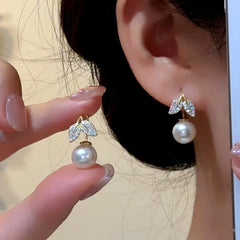 Angled view of the 14K Gold-Plated Elegant Zircon Leaf Pearl Ear Hook Earrings