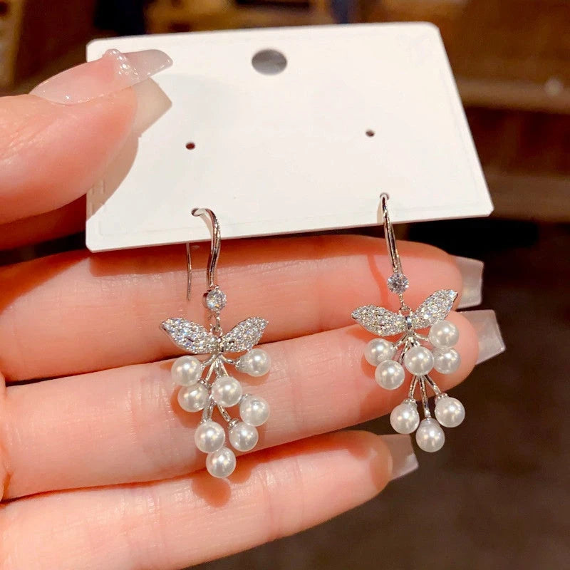 Angled view of the 14K Gold-Plated Elegant Zircon Leaf Pearl Ear Hooks