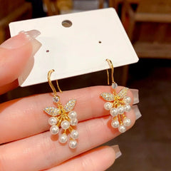 Close-up detail of the sparkling zircons and plating on the gold pearl earrings