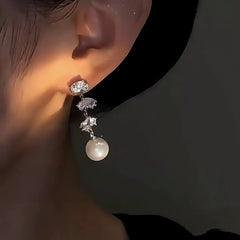 Model showcasing the dangle and style of the 14K Gold-Plated Elegant Zircon Leaf Pearl Earrings