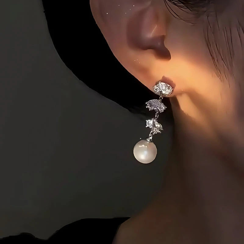 Close-up detail of the sparkling zircons and plating on the gold pearl earrings