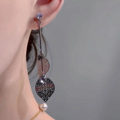 Model showcasing the dangle and style of the 14K Gold-Plated Elegant Zircon Leaf Sequin Tassel Earrings