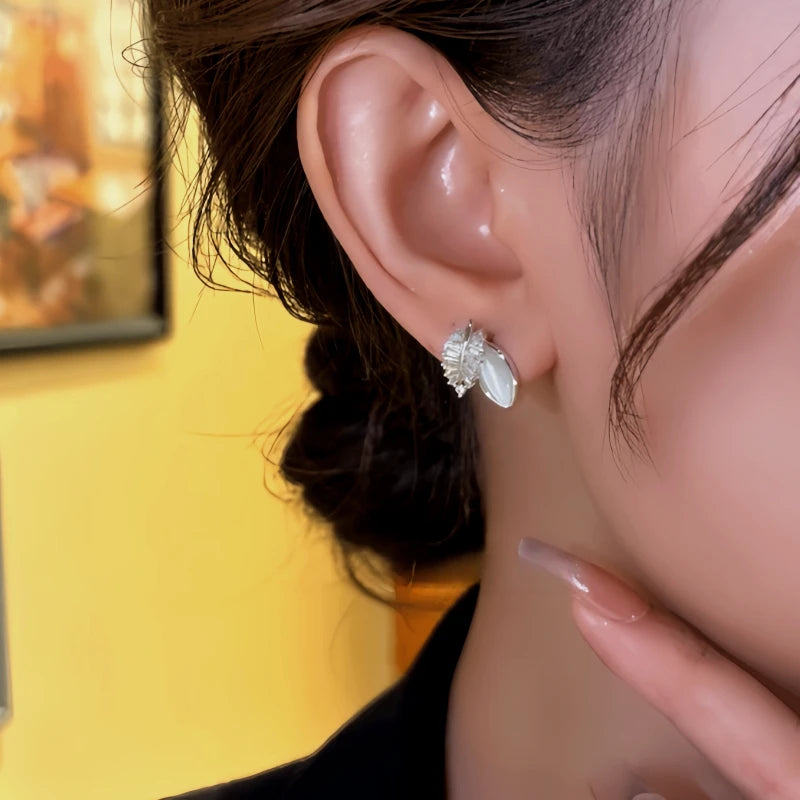 Close-up detail of the sparkling zircons and plating on the silver leaf earrings