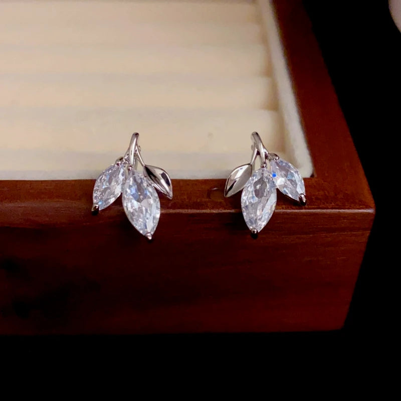 Model showcasing the dangle and style of the 14K Gold-Plated Elegant Zircon Leaf Studs