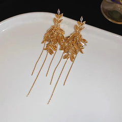 Model showcasing the dangle and style of the 14K Gold-Plated Elegant Zircon Leaf Tassel Earrings