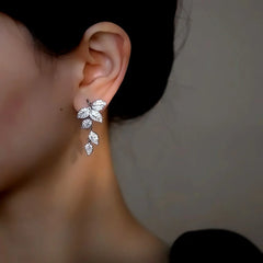 Close-up detail of the sparkling zircons and plating on the silver tassel earrings