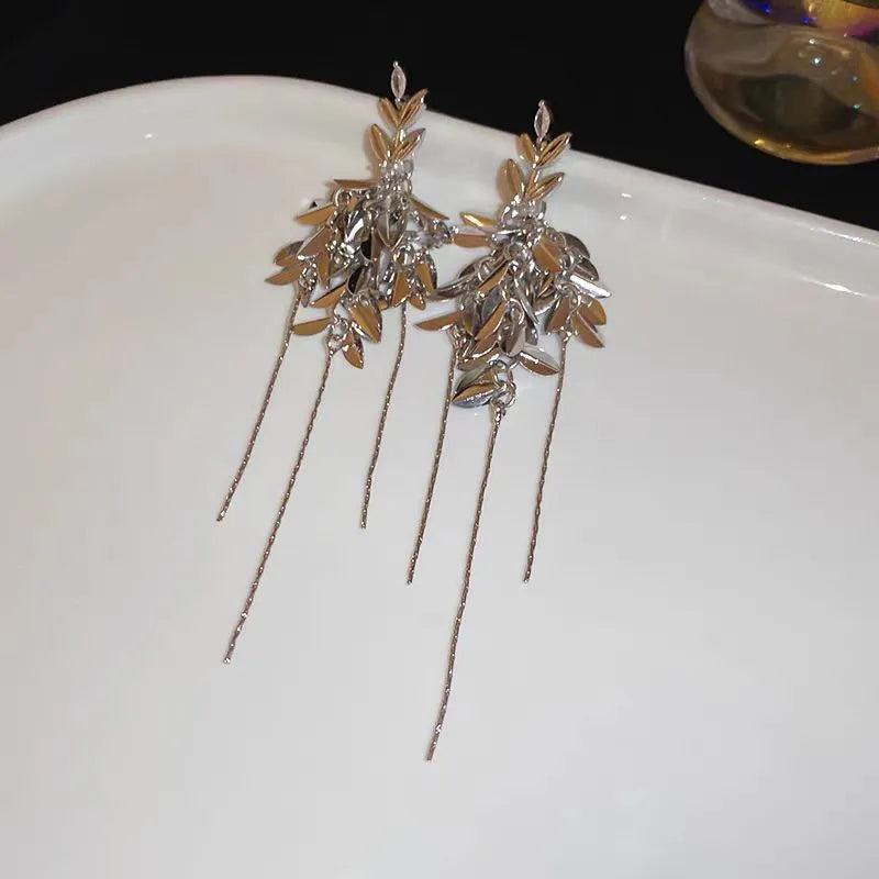 Close-up detail of the sparkling zircons and plating on the gold tassel earrings