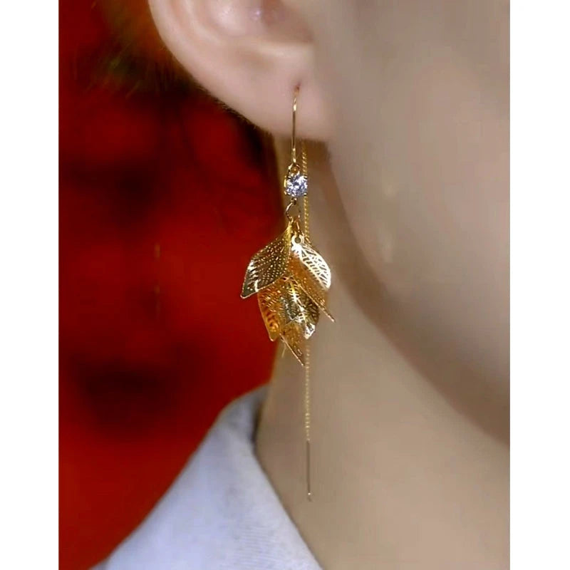 Model showcasing the dangle and style of the 14K Gold-Plated Elegant Zircon Leaf Tassel Threader Earrings