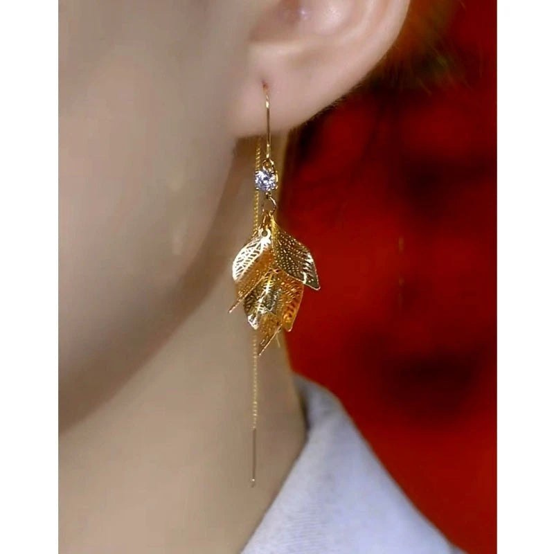 Close-up detail of the sparkling zircons and plating on the gold threader earrings