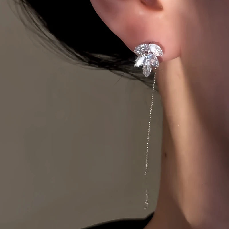 Model showcasing the dangle and style of the 14K Gold-Plated Elegant Zircon Leaf Threader Earrings