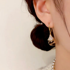 Close-up detail of the sparkling zircons and plating on the gold threader earrings