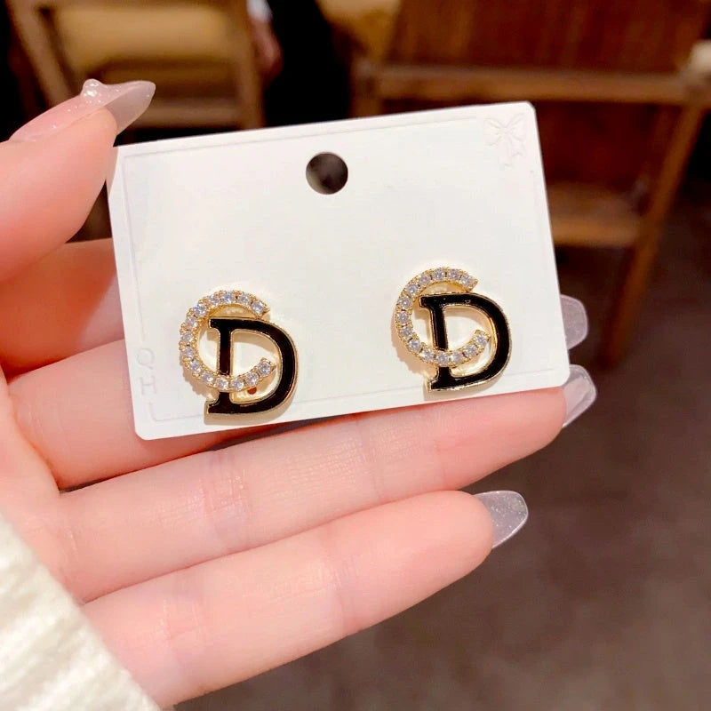 Close-up detail of the sparkling zircons and plating on the gold stud earrings