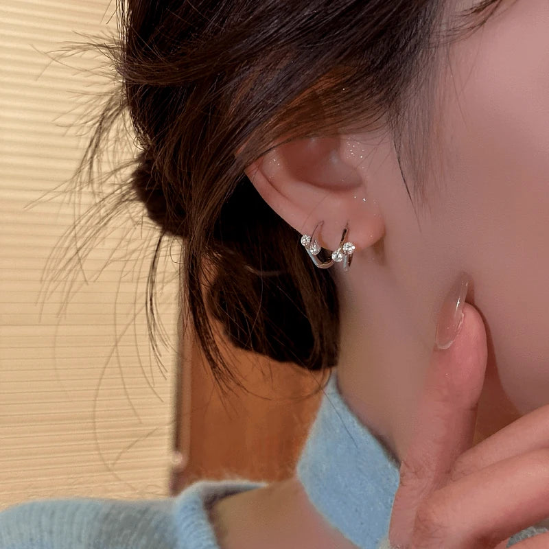 Model showcasing the dangle and style of the 14K Gold-Plated Elegant Zircon Little Hoop Earrings