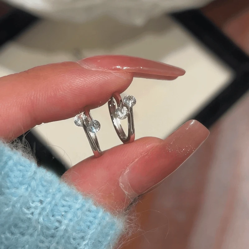 Close-up detail of the sparkling zircons and plating on the silver hoop earrings